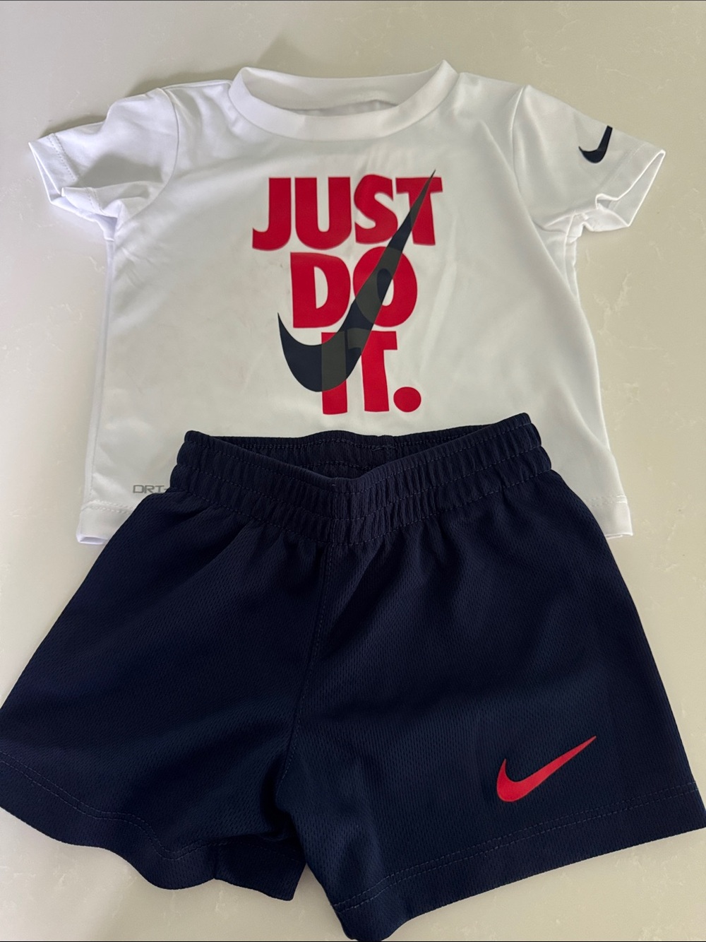 Nike White Tee with Red & Black Graphic and Navy Shorts